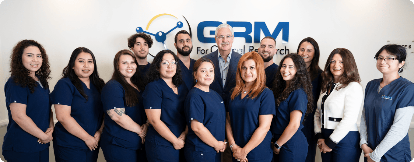 Team of diverse research professionals in blue uniforms at GRM - Global Research Management.