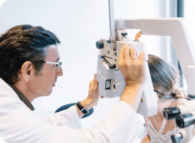 Medical researcher analyzing samples using a microscope in a clinical research setting.